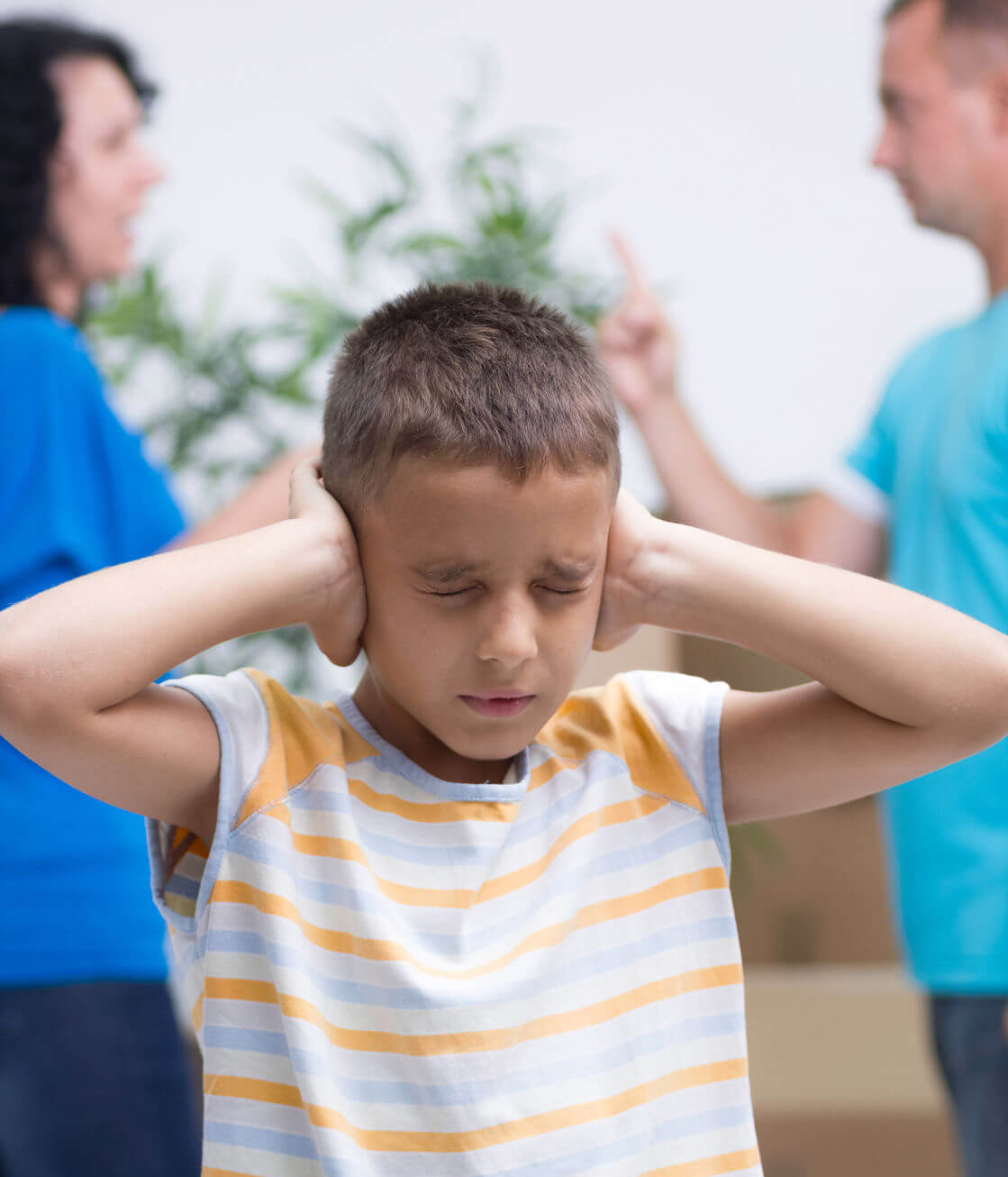boy covering his ears to avoid domestic violence