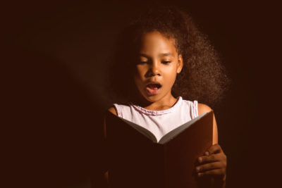 child reading aloud - American SPCC prevent child maltreatment